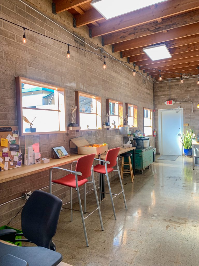 http://wooden-walls-with-mirrors-a-long-bar-table-with-red-chairs